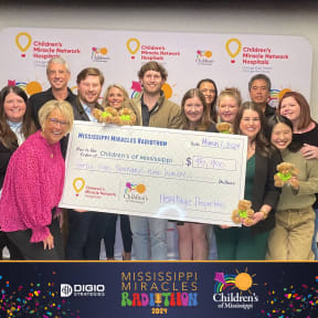 a group of people holding a large cheque