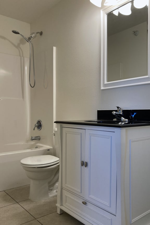 a bathroom with a toilet and a sink and a bath tub