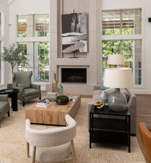 a living room with a fireplace and a table and chairs