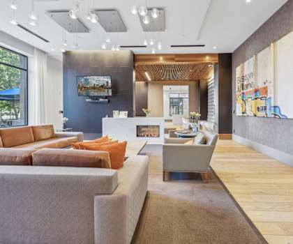A modern living room with a grey sofa and a wooden coffee table.
