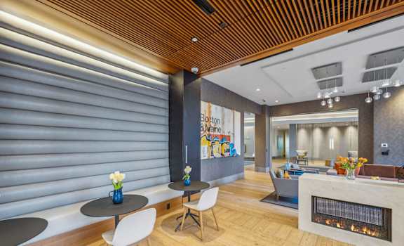 A modern living room with a fireplace and a dining table.
