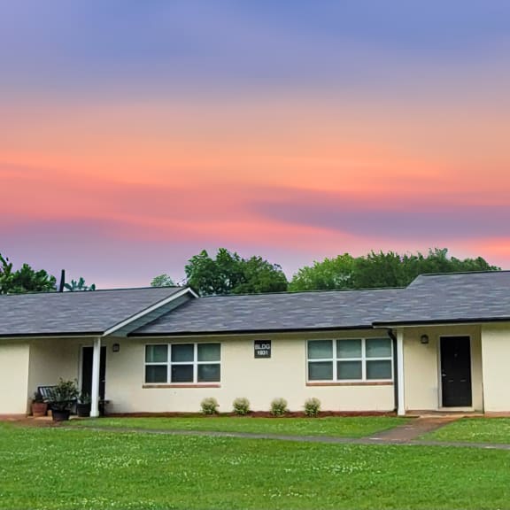 a white house with a sunset in the background