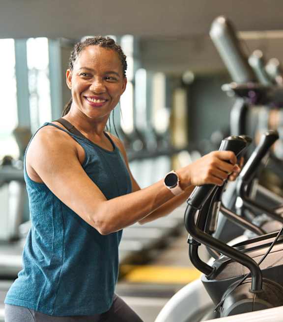 A woman is working out on a treadmill in a gym.