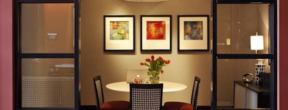 A dining room with a table set for two.