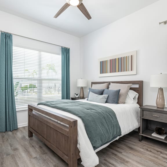 an open concept living room and dining area with a white dining table and rattan chairs at Artesia at Lakewood Ranch Apartments, Bradenton, FL, 34211
