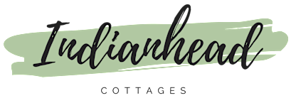 The image features the name "Indianhead" in a stylized font, with "COTTAGES" written below it.
