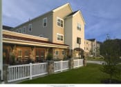 Thumbnail 1 of 5 - a rendering of an apartment building with a white fence