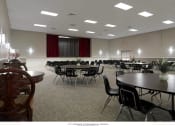 Thumbnail 4 of 5 - a large room filled with tables and chairs and a projector screen