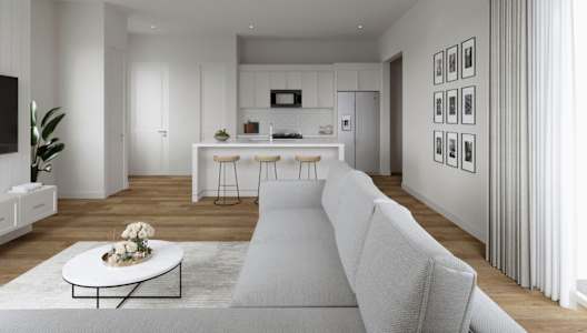 A modern living room with a white sofa, a coffee table, and a ceiling fan.