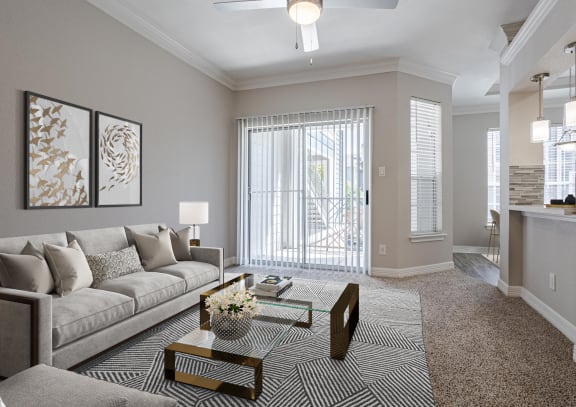 Modern living room with neutral tones, elegant décor, and an open layout leading to a balcony.