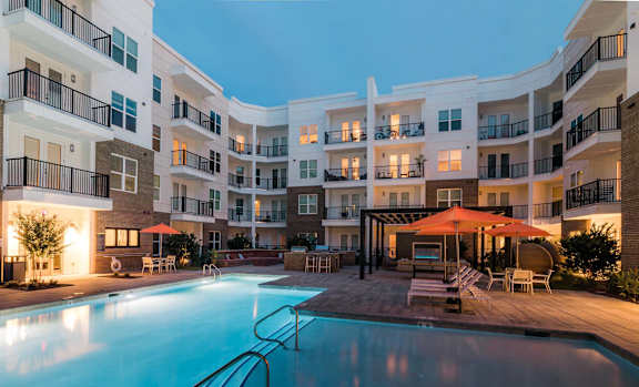 A pool with a white lounger in the foreground.