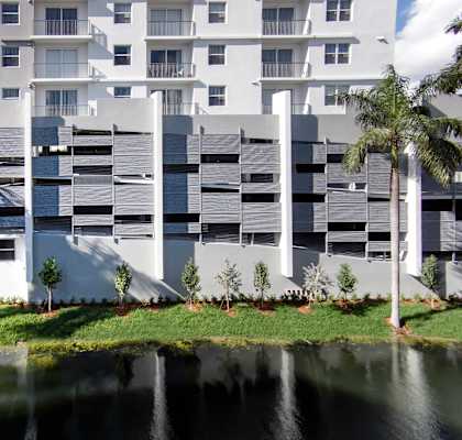 a white building with a pond in front of it