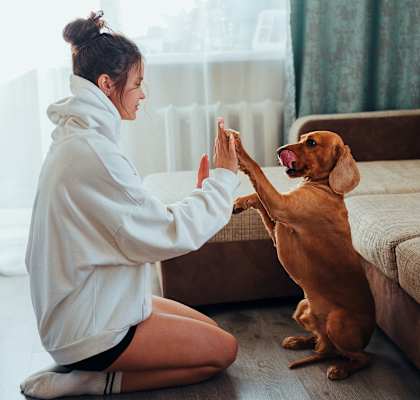 Woman with dog in living room