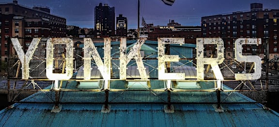 A neon sign that says YONKERS.