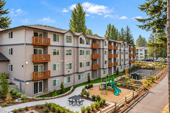 Apartment complex with a playground in the front.