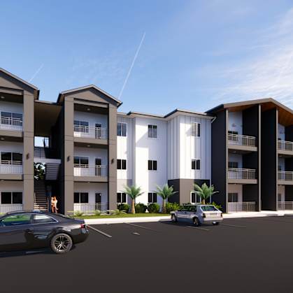 a rendering of an apartment complex with cars parked in front of it at Gibson Oaks, Lakeland, FL