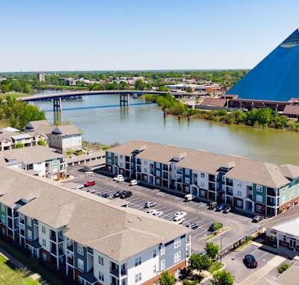 an aerial view of apartment buildings with the pyramids in the background at Grand Island Apartments in Memphis TN 38103