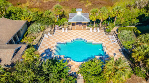 an aerial view of the pool and gazebo in the backyard of a home