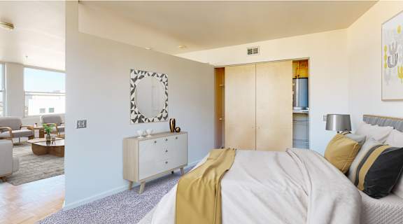 a bedroom with a bed and a dresser and a living room