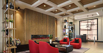 a living room with red chairs and a fireplace
