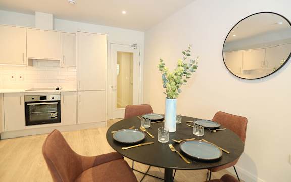 a dining room with a table and chairs and a kitchen