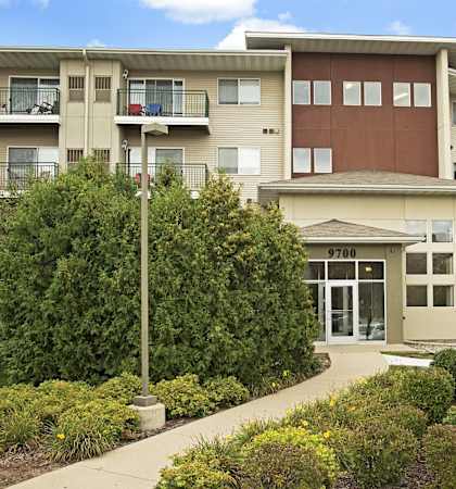 an apartment building with a sidewalk in front of it  at Shadow Hills, Minnesota, 55442