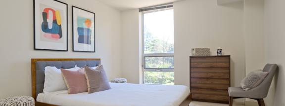 a bedroom with a bed and a dresser at 3333 Wisconsin, Washington, DC, 20016