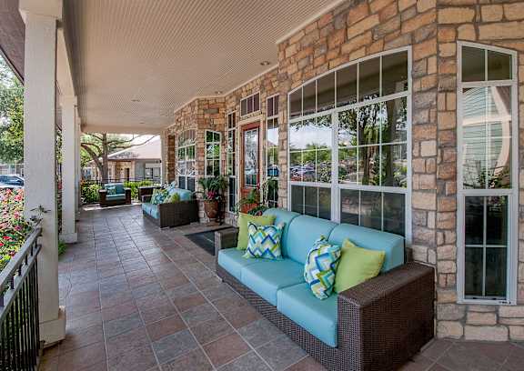 a porch with a blue couch and pillows on it at Sunrise Canyon, Universal City, TX, 78148