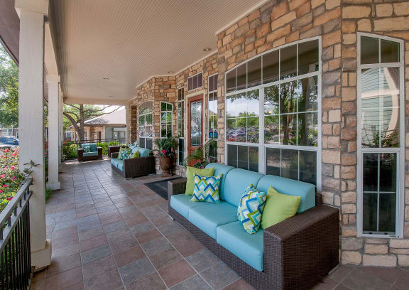 a porch with a blue couch and pillows on it at Sunrise Canyon, Universal City, TX, 78148