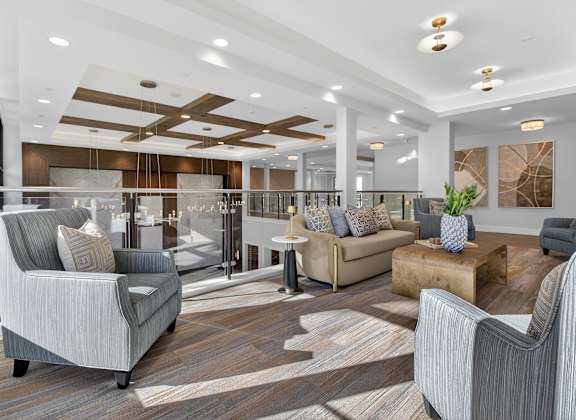 A modern living room with a grey sofa and a wooden coffee table.