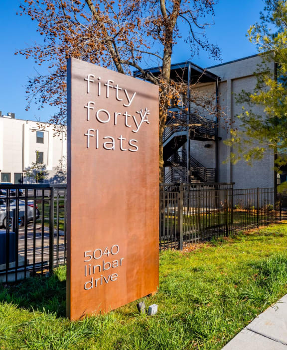 a building with a sign that reads frizzy font flats