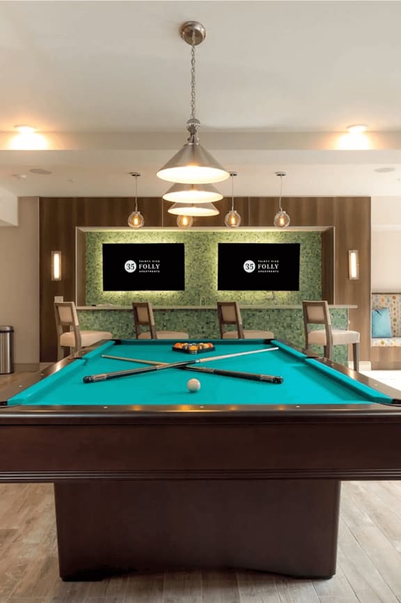 A spacious room with a mirror, exercise equipment, and a television displaying a sunset.