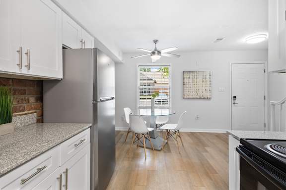 Bright dining nook at Monon Living with ceiling fan and wood-style flooring, located in Broad Ripple near trailheads and local coffee shops.
