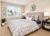 Thumbnail 5 of 8 - A bedroom with a large bed and a window with blinds.
