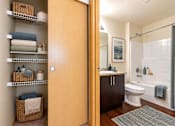 Thumbnail 4 of 8 - A bathroom with a toilet, sink, and shower.