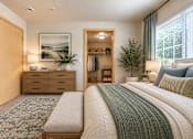 Thumbnail 6 of 8 - A bedroom with a large bed and a painting on the wall.
