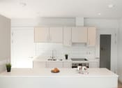 Thumbnail 2 of 7 - a white kitchen with white cabinets and a white counter top