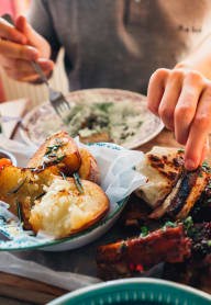 a person eating a meal at a table with other plates of food