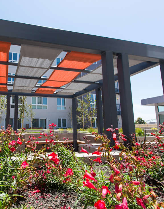 A modern building with a garden in front.
