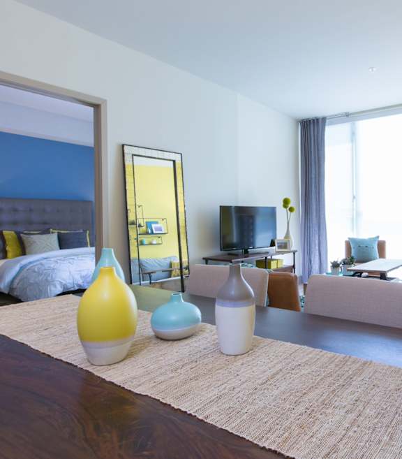 a living room with a couch and a table with vases
