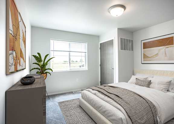A bedroom with a large bed and a window.