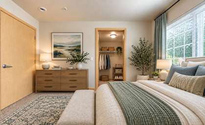 A bedroom with a large bed and a painting on the wall.