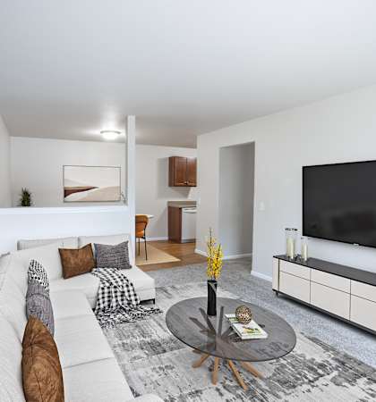 A living room with a white couch, a coffee table, and a large painting on the wall.