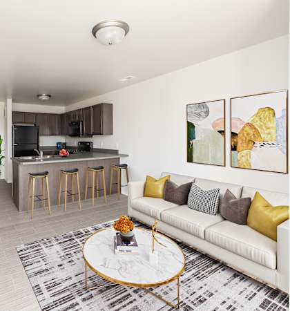 A living room with a white couch and a coffee table.