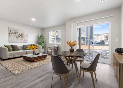 A modern dining room with a glass table and chairs.