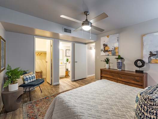 a bedroom with a large bed and a ceiling fan