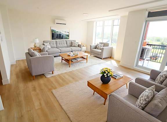 A living room with a grey couch and a coffee table.