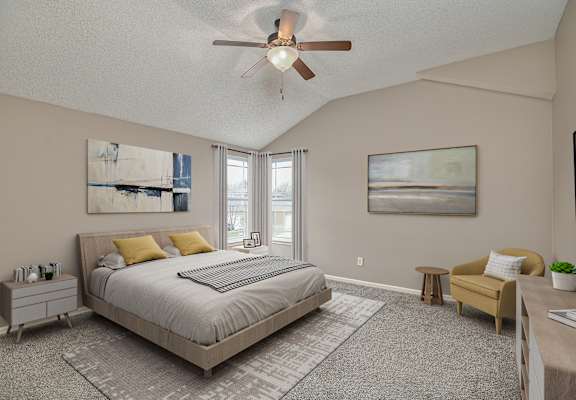 a bedroom with a large bed and a ceiling fan
