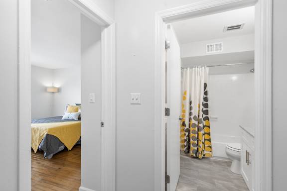 View of connected bedroom and bathroom layout at Monon Living in Broad Ripple, perfect for convenient living steps from the Monon Trail.