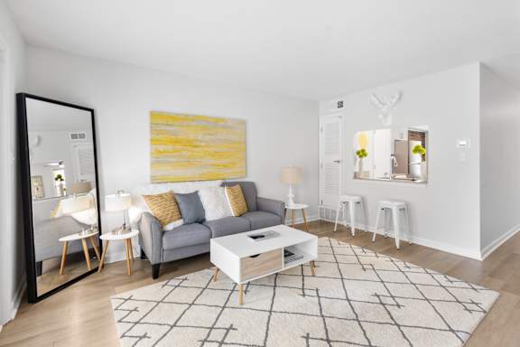 Stylish apartment living space at Monon Living in the heart of Broad Ripple with cozy seating, open breakfast bar, and walkable access to the Monon Trail.